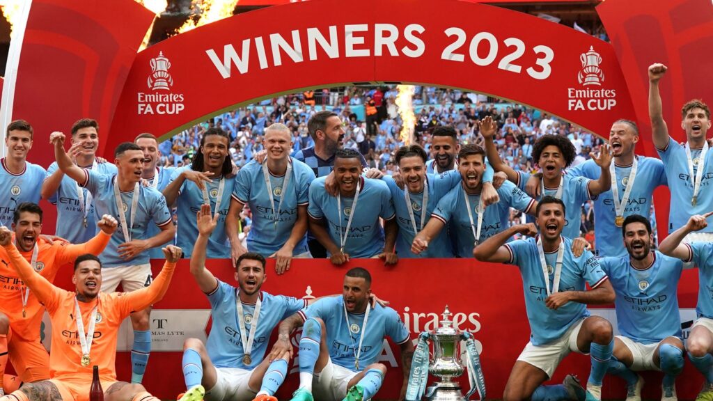 Manchester City players with FA Cup trophy.